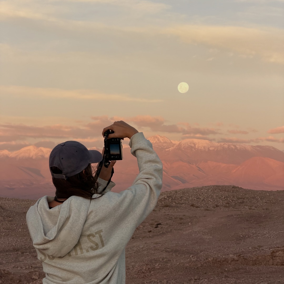 Ellen photographing the moon over the Atacama Desert at sunset