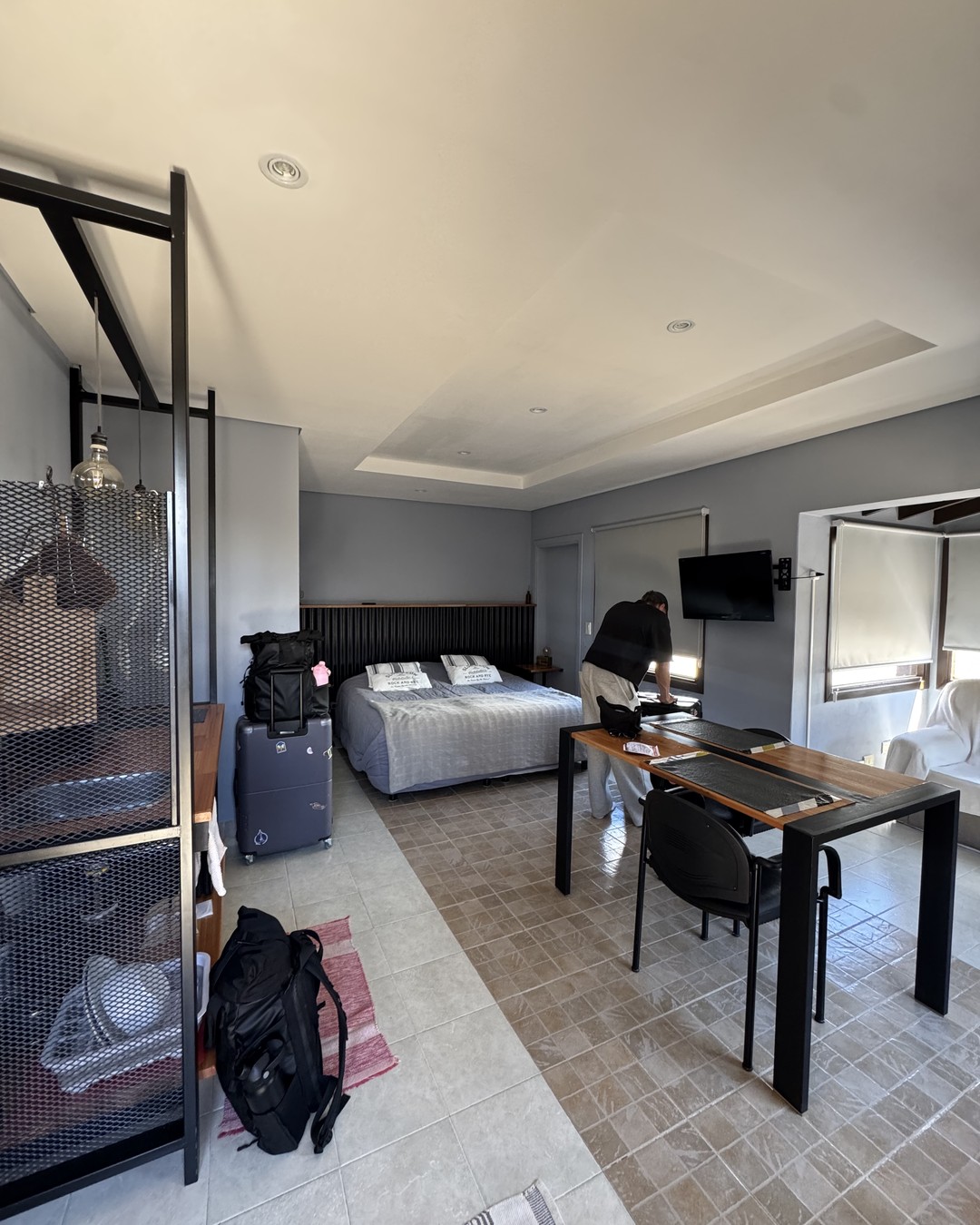 Our second El Calafate Airbnb, a studio with a bed, desk and our bags