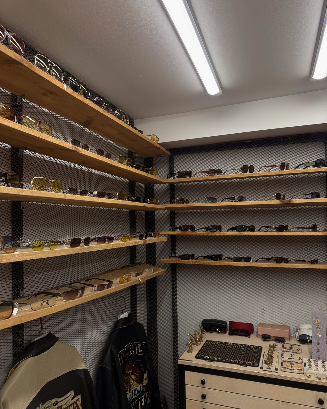 Rails and shelves of vintage clothing and sunglasses in a shop in Galata