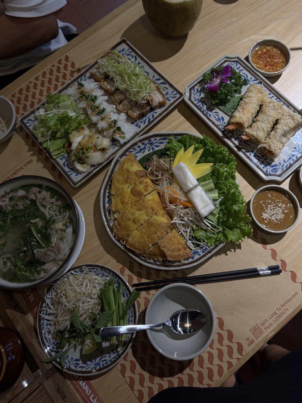 A meal with several dishes, vegetables and dipping sauces from our Da Nang photos
