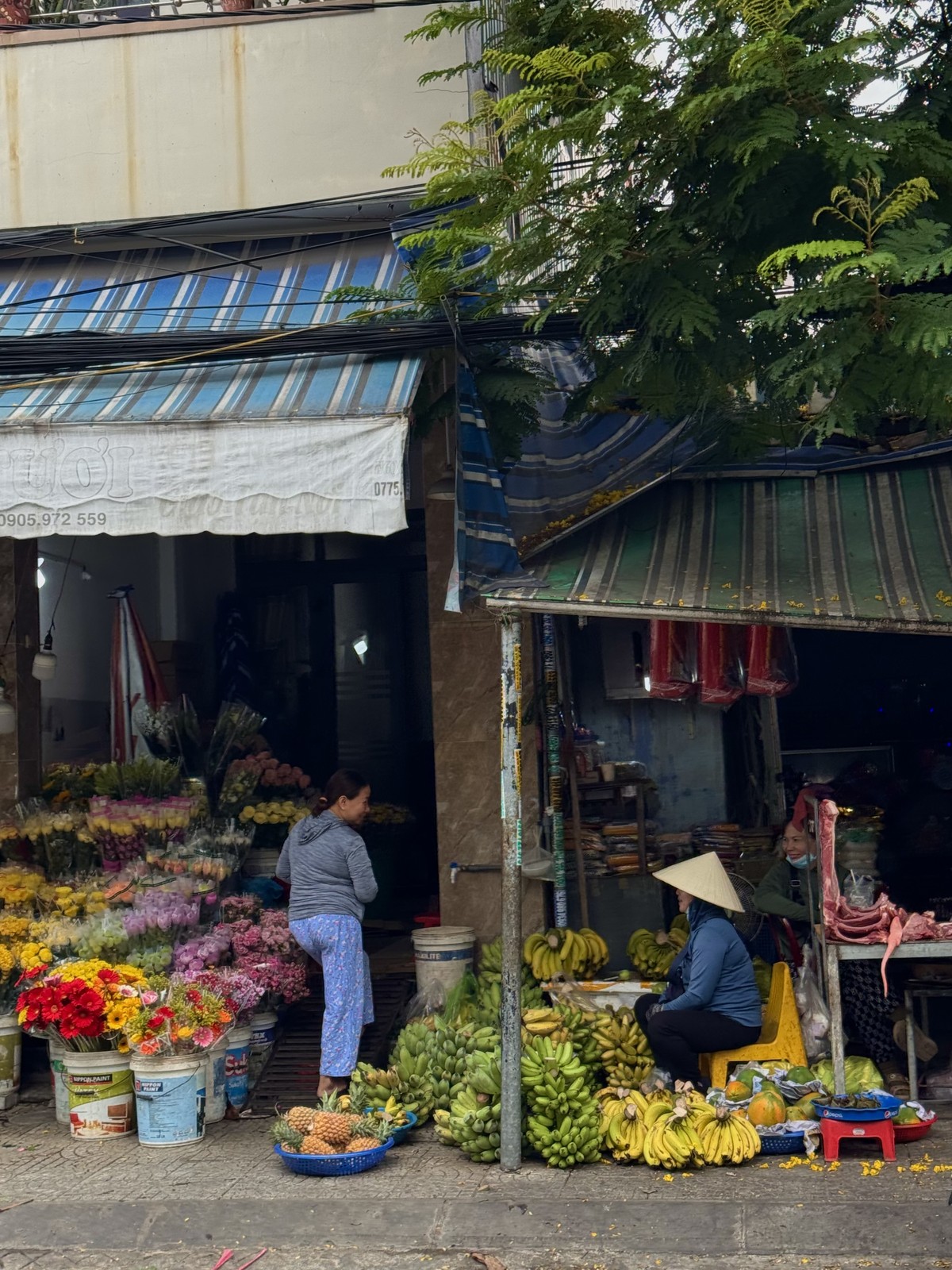 Flowers and produce outside shops at a street market in Da Nang