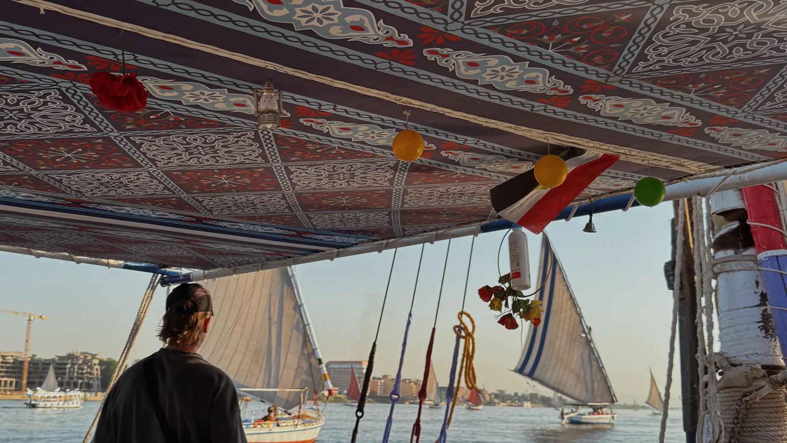 Ellen sailing on the Nile beside traditional feluccas in Luxor