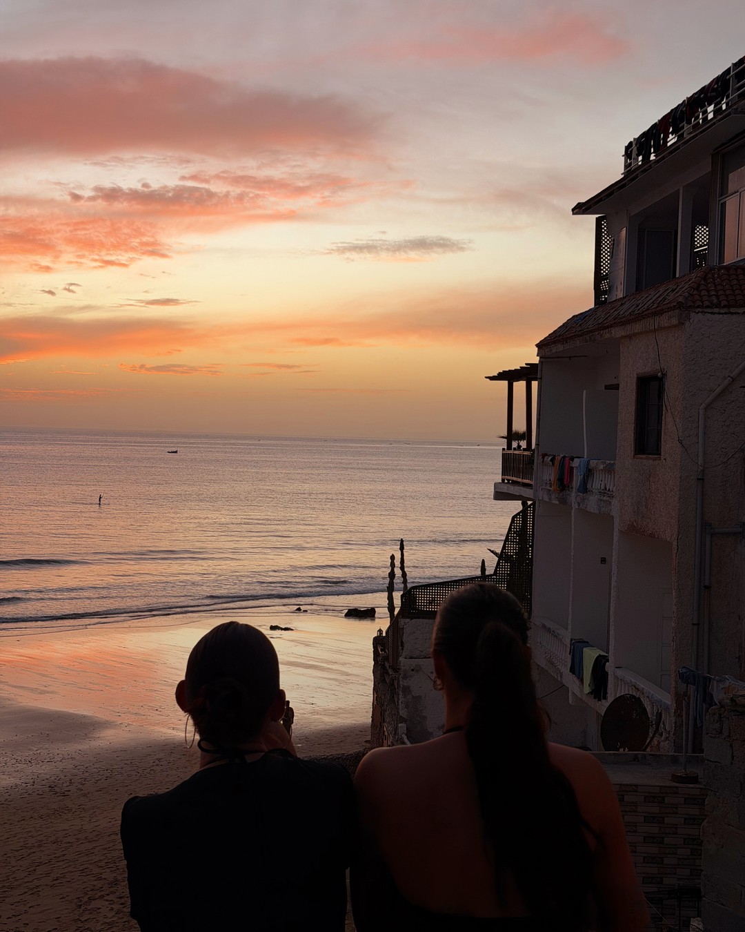 Sunset over the sea and rooftops of Taghazout on the Moroccan surf coast