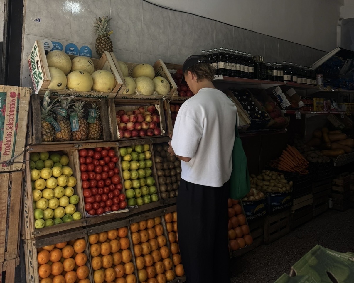 Daniel choosing fresh fruit at a neighbourhood produce shop in Palermo, Buenos Aires
