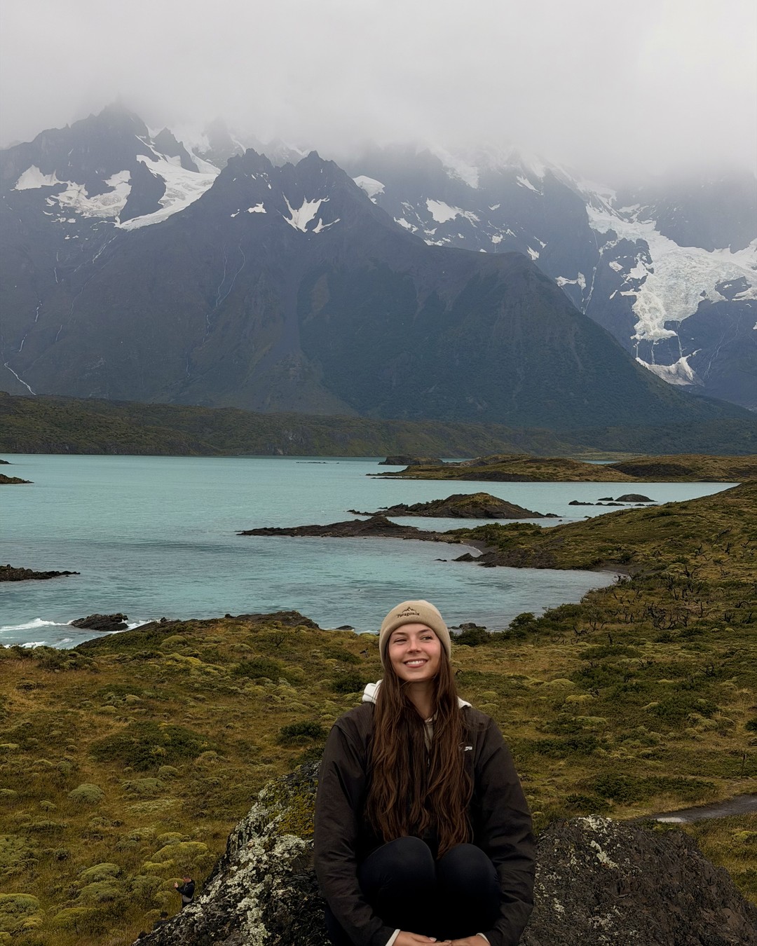 Ellen sitting in front of a lake in Torres del Paine