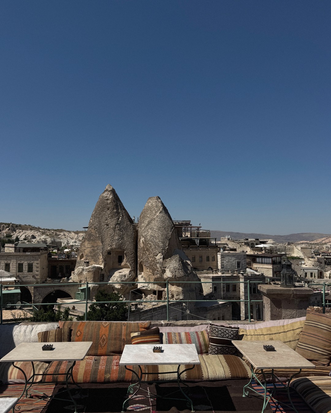 Fairy chimneys and cave houses above a rooftop terrace in Cappadocia