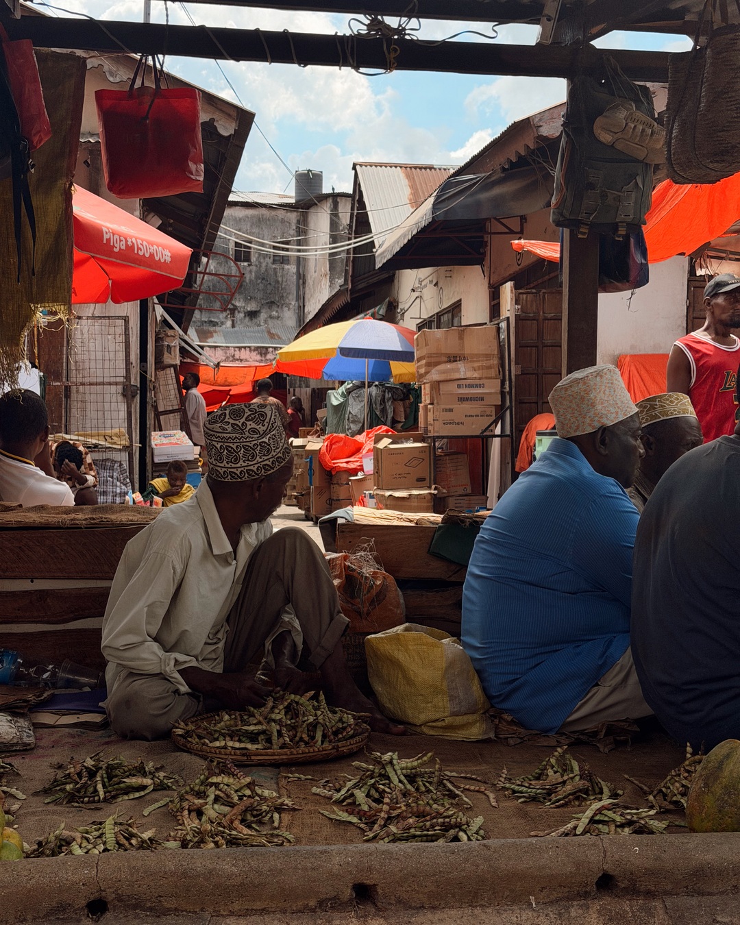 Vendors and produce at the market in Stone Town, Zanzibar